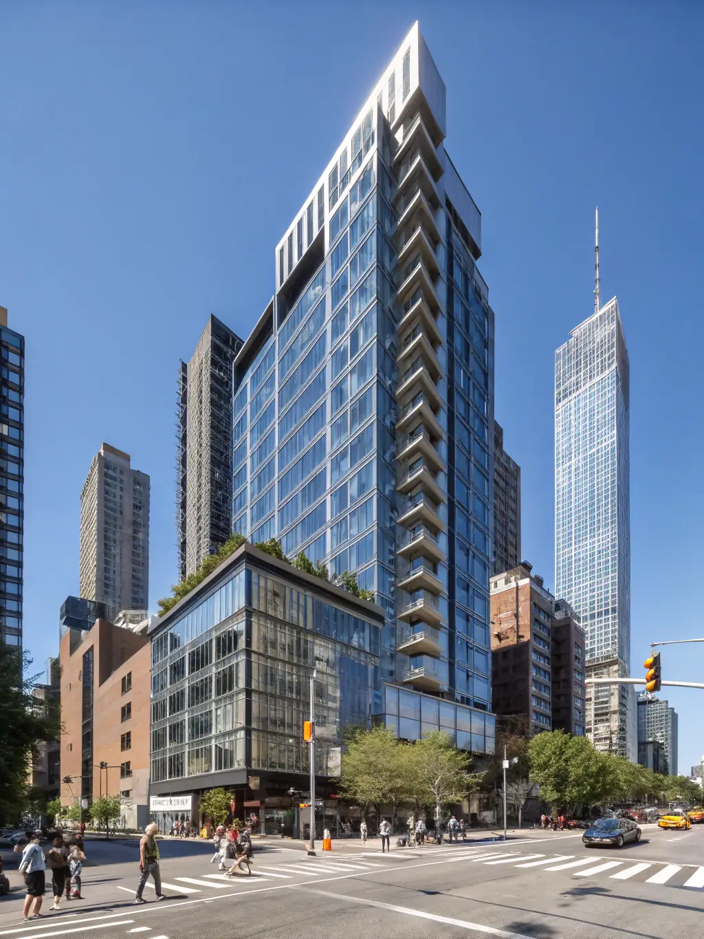 A modern high-rise apartment building in a bustling city center, representing a real estate EB-5 investment opportunity.